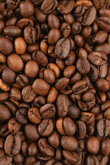 roasted whole arabica coffee beans, scattered on paper, isolated