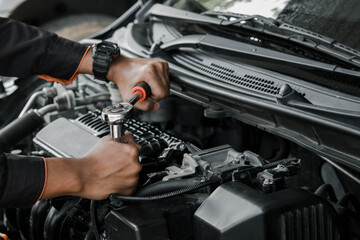 Mechanic fixing a car at home. Repair and service.