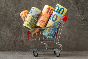 Shopping cart full of roll euro banknotes