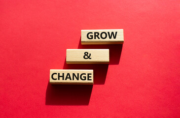 Grow and Change symbol. Wooden blocks with words Grow and Change222. Beautiful red background. Business and Grow and Change concept. Copy space.