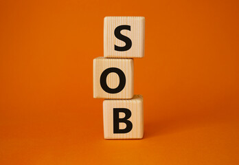 SOB - Shortness of breath symbol. Wooden cubes with words SOB. Beautiful orange background. Medical...