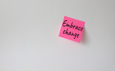Embrace change symbol. Pink steaky note with concept words Embrace change. Beautiful white background. Business and Embrace change concept. Copy space