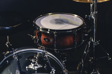 Obraz na płótnie Canvas Snare drum on a blurred dark background, part of a drum kit.