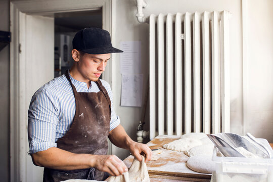 Baker preparing dough in kitchen