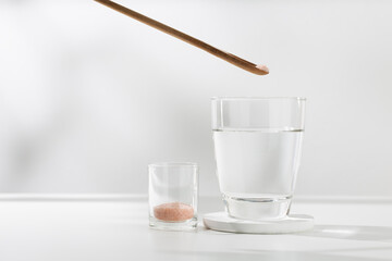 Mix pink himalayan mineral salt to drinking water for health. - obrazy, fototapety, plakaty