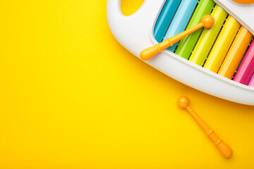 Colorful xylophone on yellow background. Space for text