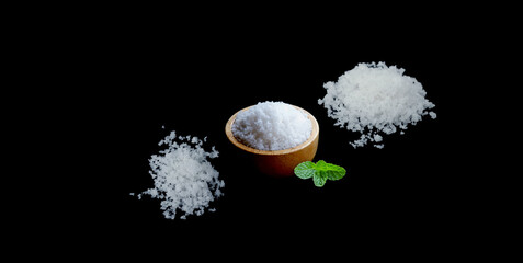 Rock salt in wooden spoons, wooden bowls for condiment design