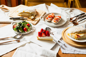 Strawberry slice cake and food on the table