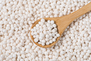 white sago pearls or sago balls in spoon background. - obrazy, fototapety, plakaty