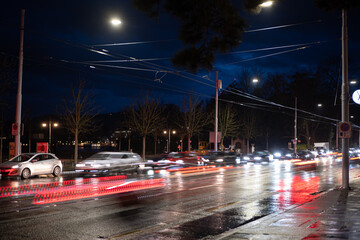 Heavy car traffic at night in a European city. Long exposure, car light trails, traffic light, late...