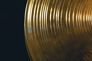 Fototapeta na wymiar Drum cymbal close-up on a dark background, top view.