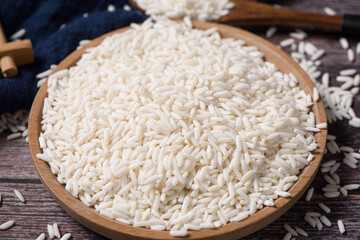 Organic raw sticky rice or glutinous rice  on table