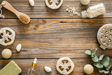 Spa composition with body care items on wooden background, top view.
