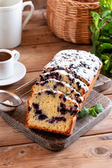 Lemon blueberry cake with fresh berries on top on the board on wooden table