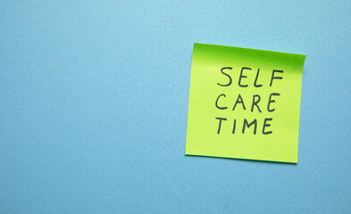 Self care time on sticky note.