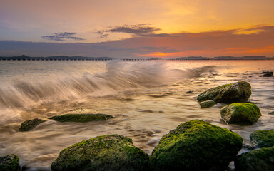 Tide rising and crashing waves at Changi park beach during early morning - Singapore
