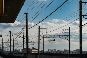 架線の向こうに広がる雲の浮かぶ青空
