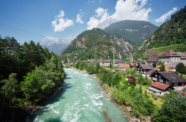 Fototapeta na wymiar Swiss landscape with river stream and houses.