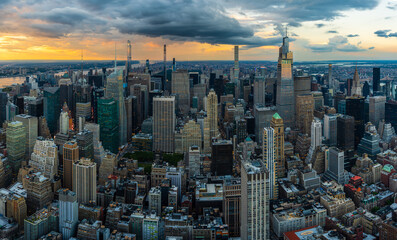 A rain storm over the midtown Manhattan in New York City during beautiful sunset.