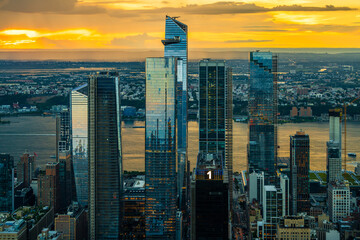 An orange sunset over the Hudson Yards in New York City.