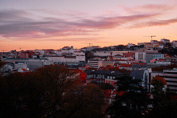 Beutiful view of old town in Lisbon. Red tiled roofs and sunset sky.