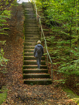 A senior starting the challenge of climbing up a long, steep set of steps in the Bradford District countryside