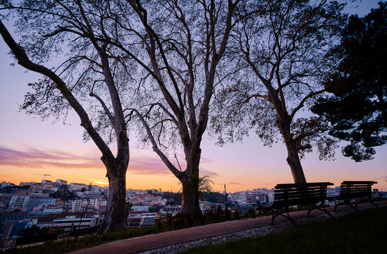 Miradouro do Jardim do Torel. Beutiful view of old town in Lisbon. Red tiled roofs and sunset sky.