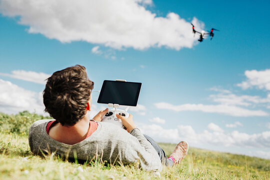 Man flying drone using remote control