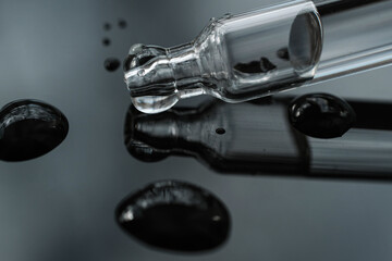 Drops of oil or gel with pipette on gradient background. Concept of making researches in care...