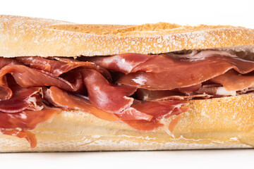 Spanish serrano ham sandwich isolated on white background.
