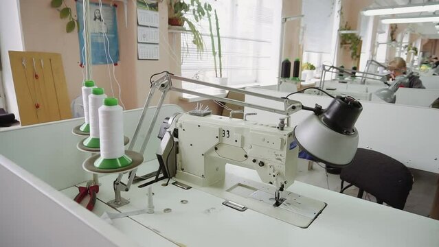 Sewing machine lamp and thread coils at seamstress workplace