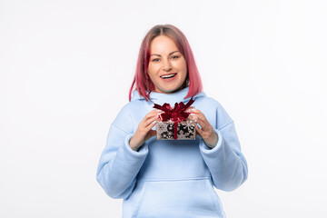 Holidays, celebration and women concept. Portrait of happy charismatic woman shaking gift box wondering what's inside as celebrating birthday, receive b-day presents, white background