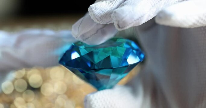 Person shows large blue diamond at gemstone exhibition