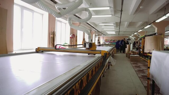 Corrugated plastic pipe connected to cutter on conveyor