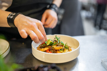 Chef cooking Stir fry noodles with vegetables and shrimps on restaurant kitchen