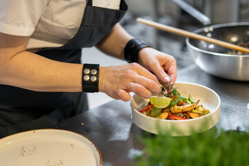 Chef cooking Stir fry noodles with vegetables and shrimps on restaurant kitchen