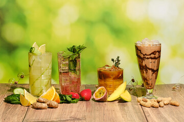 Set of cold refreshing summer drinks on wooden table