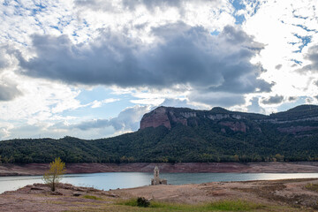Sau reservoir very dry with little water and bell tower of San roman de Sau in Girona Catalonia Spain