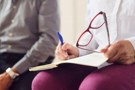 Mid section of woman taking notes