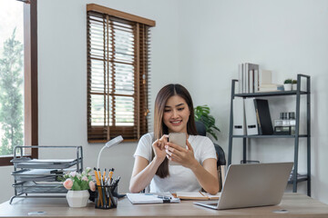 business woman with phone for communication, connection and typing while smile, happy and relax. Entrepreneur, excited and with laptop for planning at home