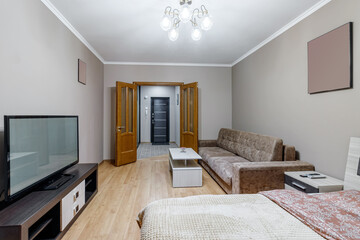Gomtinaya in a small apartment with sofa, TV, large bed and coffee table
