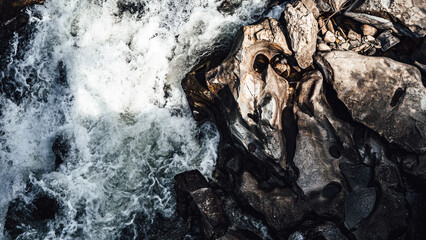 natural environment, water falling on rocks.
shapes and textures of water and rock.