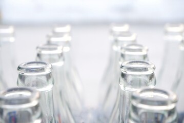 In Selective focus many empty grass bottles in a row with white background 