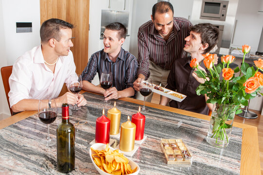 Gay Lifestyle: Entertaining Friends. A group of same sex friends enjoying a glass of wine and each others company. From a series of related images.