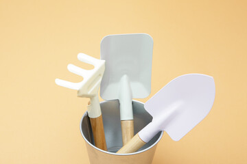 Fototapeta premium Garden tools in a metal bucket. Gardening concept. Minimalism, close-up.