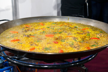 chicken paella cooking on gas stove