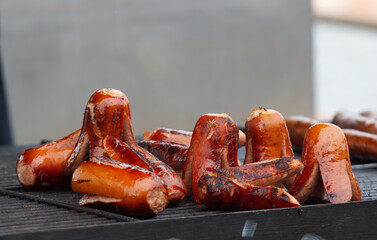 Grilling of sausages and kielbasa at the farmers street food market in Prague, no smoke, no people, no AI.