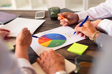 Business people analyzing charts during meeting