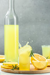 Glass of limoncello traditional Italian alcoholic drink. Freeze motion splash drops of liqueur....