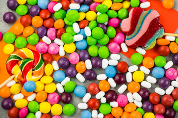 Fototapeta na wymiar Skittles candy on the colorful table, colorful sweet candy